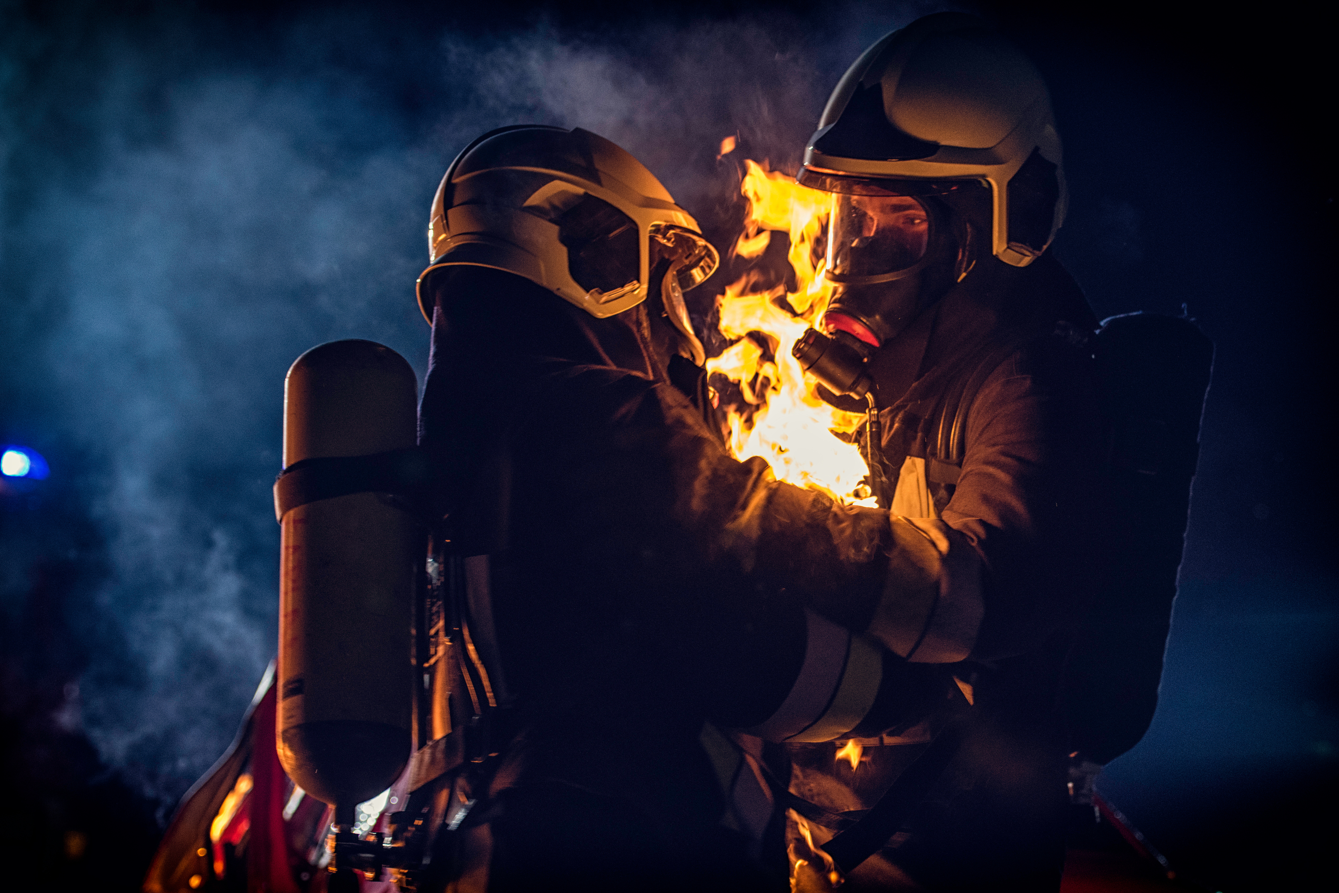 Firefighter helping another fireman